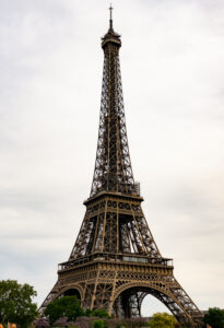 View of the Effiel Tower from below surrounded by flowering trees in springtime in Paris, France.